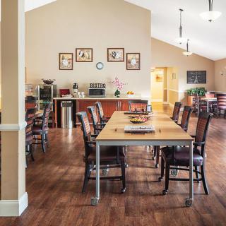 Spacious dining room with wooden furniture and elegant decor.