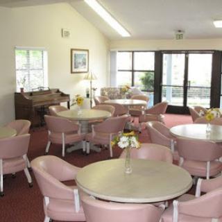 A cozy and inviting lounge area furnished with round tables and comfortable chairs, perfect for gathering.