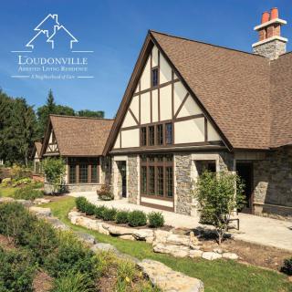 A picturesque stone cottage surrounded by a beautifully landscaped garden.