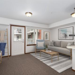 A modern living room featuring a comfortable sofa, coffee table, and stylish decor.