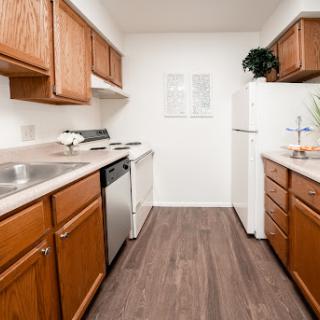 A modern kitchen featuring wooden cabinets and essential appliances.