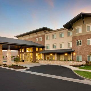 A modern hotel building with a welcoming entrance and well-maintained landscaping.