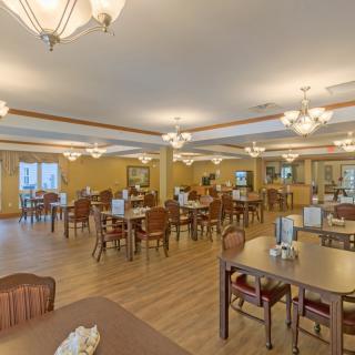 A spacious dining area with neatly arranged tables and elegant lighting.