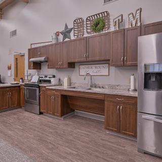 A modern kitchen with wooden cabinets and stainless steel appliances.