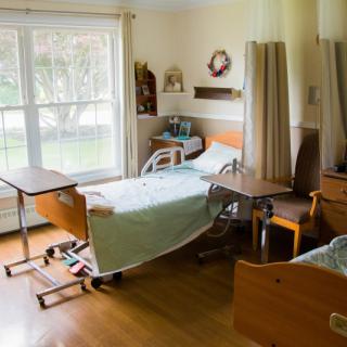 A hospital room with two beds, equipped for patient care.