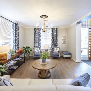 A beautifully decorated modern living room with elegant furnishings and natural lighting.