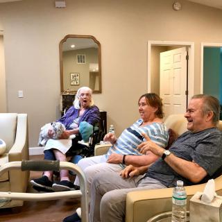 A group of seniors relaxing and socializing in a cozy living room.