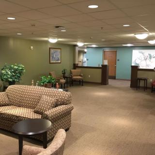 A spacious and well-lit waiting room with comfortable seating and a reception desk.