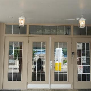A welcoming entrance featuring double doors and decorative lanterns.