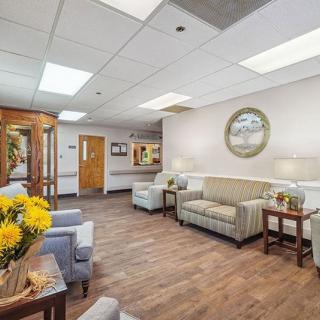 A cozy waiting room featuring comfortable seating, decorative elements, and a warm ambiance.
