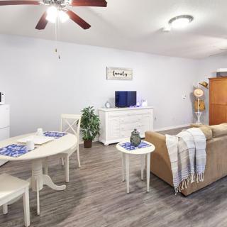 A modern living room with a cozy sofa, dining area, and decorative elements.