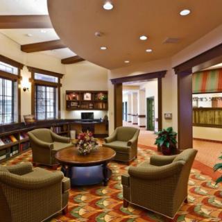 A cozy library interior with comfortable seating and bookshelves.