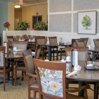 A neatly arranged dining room with wooden furniture and decorative elements.