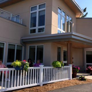 A charming two-story house with a welcoming exterior and colorful flower arrangements.