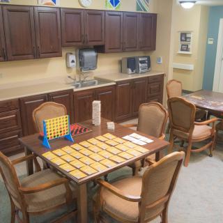 A cozy kitchen and dining area with board games set up on a table.