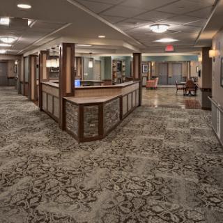 A spacious and elegantly designed hotel lobby featuring a reception desk and comfortable seating areas.