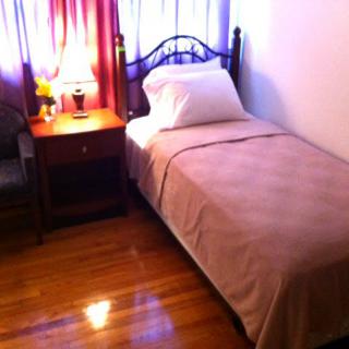 A cozy bedroom with a single bed and nightstand.