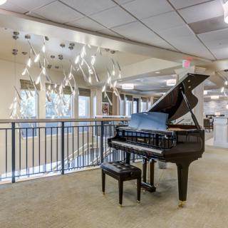 A grand piano positioned in a modern lobby setting.