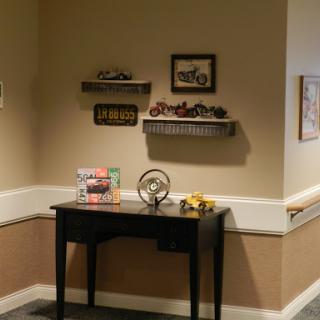 A cozy corner showcasing vintage decor with shelves and a stylish black table.