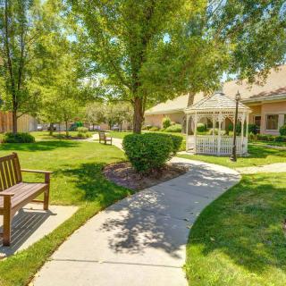 A serene outdoor park featuring a winding walkway, lush greenery, and a charming gazebo.