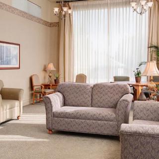 A spacious living room with comfortable seating and large windows.