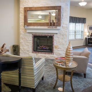 A cozy living room featuring a stylish fireplace and comfortable seating.