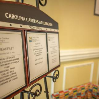A display board showcasing the menu at Carolina Gardens.
