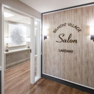 Entrance to a salon with wood paneling and elegant signage.