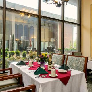A well-appointed dining area with elegant table settings and large windows.