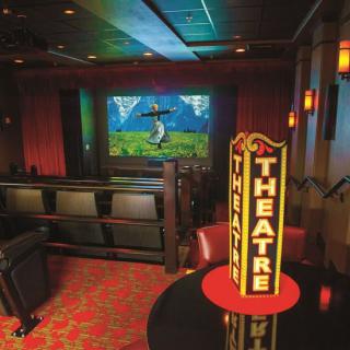 A cozy theater interior with a classic movie screen and seating.