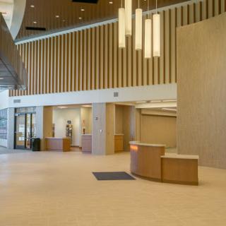 A spacious and modern lobby area with a reception desk and contemporary lighting.
