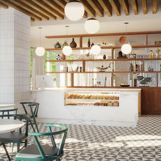 A modern cafe interior with stylish lighting and geometric floor tiles.