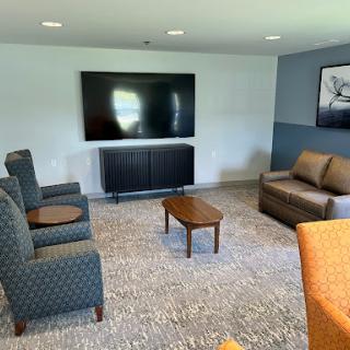 A cozy living room setup featuring a television, comfortable seating, and a warm atmosphere.