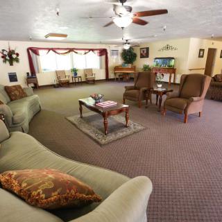 A spacious living room with comfortable seating and classic decor.
