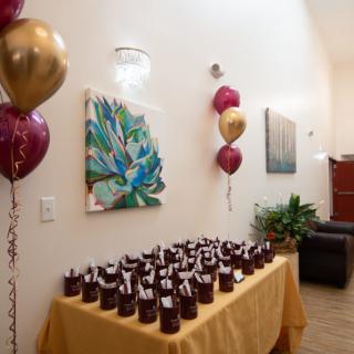 A decorated space with balloons and a table full of party favors.