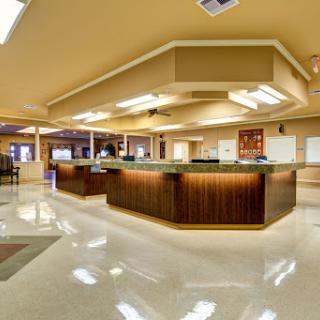 A modern and inviting lobby area featuring a sleek reception desk and polished marble flooring.