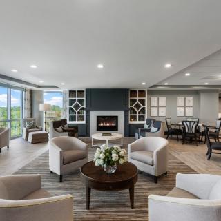 A modern living room with comfortable seating and a cozy fireplace.