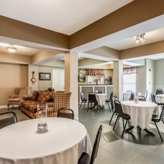 A cozy reception area with dining tables and a lounge section.