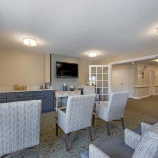 A modern living room with comfortable seating and a TV mounted on the wall.