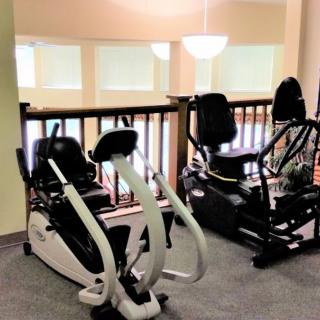 A gym area featuring cardio exercise machines.