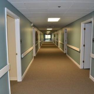 A long, empty hallway with doors on either side.