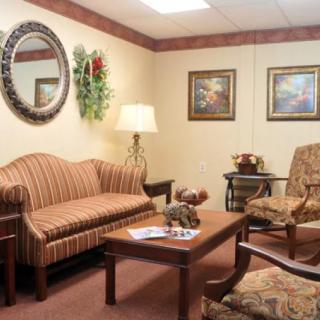 A cozy waiting room with comfortable seating and decor.