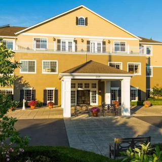 A well-maintained residential building with a welcoming entrance and landscaped surroundings.