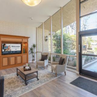 A bright and inviting lobby featuring modern furniture and large windows that allow natural light to fill the space.