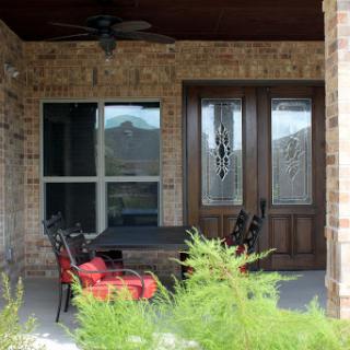 A peaceful porch area featuring comfortable seating and decorative elements.