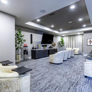 A stylish and modern home theater setup featuring comfortable seating and a sleek entertainment system.