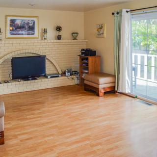 Bright and minimalist living room with hardwood floors and a sliding glass door.