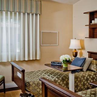 A cozy bedroom with patterned bedding and a warm ambiance.