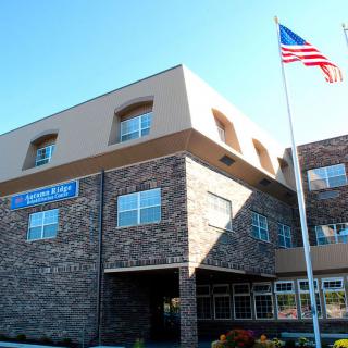 Front view of a hospital building with an American flag outside.