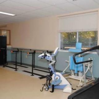 A rehabilitation center equipped with exercise equipment and tools for physical therapy.